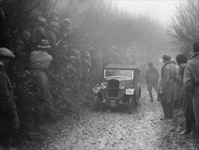 Triumph saloon of CH Lawford competing in the MCC Exeter Trial, 1930. Artist: Bill Brunell.