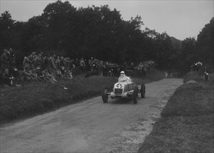Unidentified open single-seater car competing in the Shelsley Walsh Hillclimb, Worcestershire, 1935. Artist: Bill Brunell.