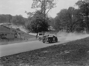 Two Wolseleys racing, Donington Park Race Meeting, Leicestershire, 1933. Artist: Bill Brunell.