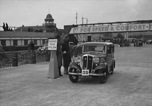 Standard Nine saloon competing in the JCC Rally, Brooklands, Surrey, 1939. Artist: Bill Brunell.