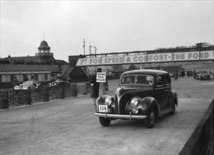 Ford V8 saloon competing in the JCC Rally, Brooklands, Surrey, 1939. Artist: Bill Brunell.