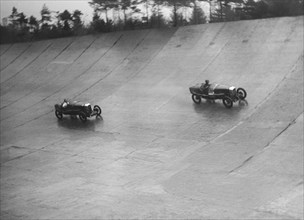 Two Salmsons racing on the banking at a BARC meeting, Brooklands, Surrey, 1931 Artist: Bill Brunell.