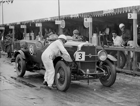 Studebaker of A Hollidge and GAW Laird in the pits at the JCC Double Twelve Race, Brooklands, 1929. Artist: Bill Brunell.