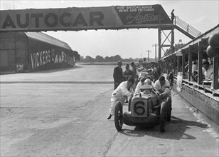 'Rubber Duck', works Austin 7 of Charles Goodacre in the pits, BRDC 500 Mile Race, Brooklands, 1931. Artist: Bill Brunell.