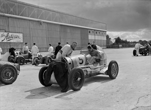 Cars of George Harvey-Noble, Charles Goodacre and Bert Hadley, BRDC 500 Mile Race, Brooklands, 1937. Artist: Bill Brunell.
