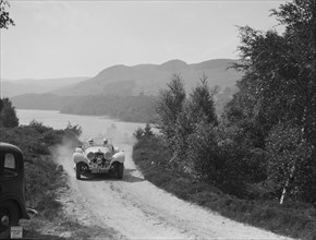 SS Jaguar 100 open 2-seater of Miss E Violet Watson competing in the RSAC Scottish Rally, 1939. Artist: Bill Brunell.