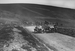Lagonda of WH Oates and DFP of JC Douglas competing in the Scottish Light Car Trial, 1922. Artist: Bill Brunell.