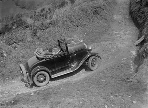 Kitty Brunell driving a 1930 2-seater Ford Model A, 1931.   Artist: Bill Brunell.