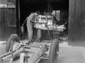Working on the engine of Raymond Mays' Vauxhall-Villiers, c1930s. Artist: Bill Brunell.