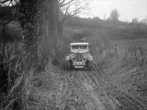 MG 18/80 saloon of R Gough competing in the MG Car Club Trial, Kimble Lane, Chilterns, 1931. Artist: Bill Brunell.