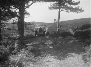 Kitty Brunell road testing a Riley 9 WD tourer, c1930. Artist: Bill Brunell.