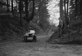 MG M Type standard 2-seater competing in the JCC Half-Day Trial, Hurtwood Hill, Surrey, 1930. Artist: Bill Brunell.