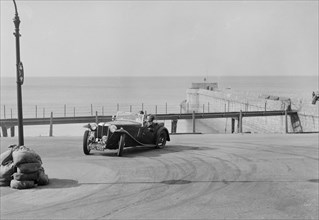 MG TA of FG Cornish competing in the RAC Rally, Madeira Drive, Brighton, 1939. Artist: Bill Brunell.