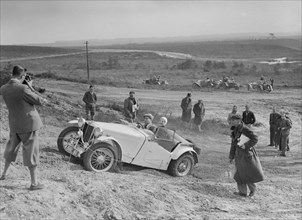 MG TA of the Cream Cracker Team competing in the Great Weat Motor Club Trial, 1938. Artist: Bill Brunell.