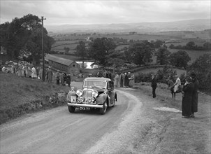 Jaguar SS saloon of DS Hand competing in the South Wales Auto Club Welsh Rally, 1937 Artist: Bill Brunell.