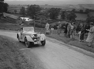 Riley Sprite 2-seater of Mrs TB Hague competing in the South Wales Auto Club Welsh Rally, 1937 Artist: Bill Brunell.