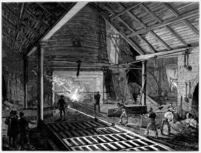 Tapping a blast furnace and running molten iron into the 'pigs', c1885. Artist: Unknown