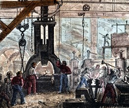 Steam hammer being used in an ironworks, France, 1867. Artist: Unknown