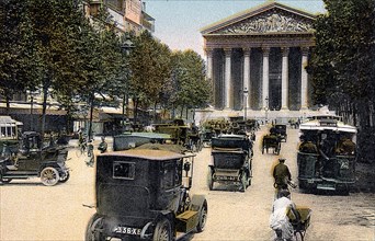 Rue Royale and the Madeleine, Paris, with cars and a motorbus on the street, c1900. Artist: Unknown