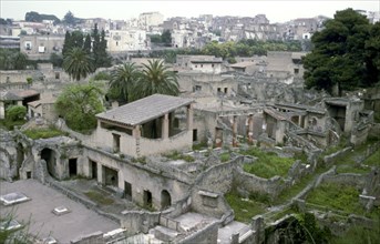 Buildings of Herculaneum with houses of the modern town of Ercolano above, Italy. Artist: Unknown