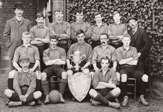 Rowntree Football Club 1st team pose with trophy and cup, York, Yorkshire, 1902. Artist: Unknown