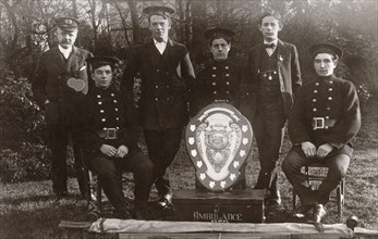 Members of the winning Rowntree Ambulance Team pose with trophy, York, Yorkshire, 24 Jan 1914. Artist: Unknown