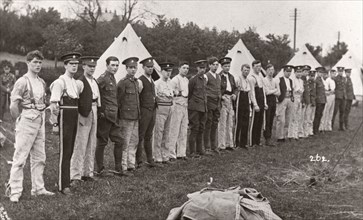 Rowntree boys line up for inspection outside their tents, Coniston, Cumbria, summer 1913. Artist: Unknown
