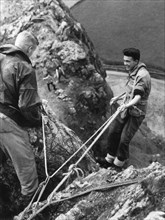 Boy about to start descent of rock face, Outward Bound School, Eskdale, Cumbria,1950. Artist: Unknown