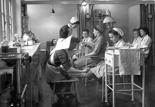 Nurses attend to staff in the Rowntree factory surgery, York, Yorkshire, 1946. Artist: Unknown