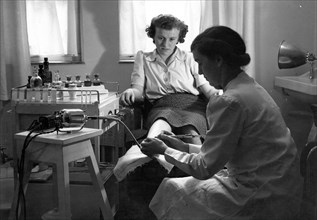 A Rowntree?s chiropodist works on a woman?s foot, York, Yorkshire, 1946. Artist: Unknown