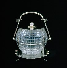 American glass biscuit barrel cut in the shape of a mesh patterned golf ball, 1910. Artist: Unknown