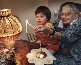 Girl lighting candles, Middlesex, London, 1989. Artist: Unknown