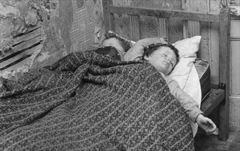 Children asleep in a slum dwelling in London's East End, 1965. Artist: Unknown