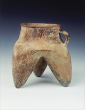 Tripod jar with strap handle and hollow legs, Qijia culture, Qinghai province, China, 1800-1500 BC. Artist: Unknown