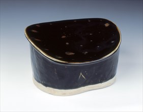 Ding black glazed pillow with hatched moulding, Jin dynasty, China, 12th century. Artist: Unknown