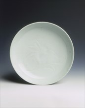 Shufu porcelain saucer with carved lotus, Yuan dynasty, China, 14th century. Artist: Unknown