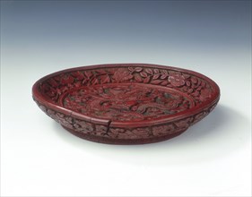 Carved red lacquer saucer with dragon amid clouds, Ming dynasty, China, late 16th century. Artist: Unknown