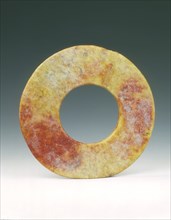 Altered jade bi-disc with russet patches, Neolithic, Liangzhu culture, China, c3400-c2250 BC. Artist: Unknown