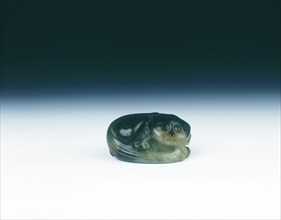 Jade cat sitting curled up scratching its ear with one eye closed, Yuan dynasty, China, 1279-1368. Artist: Unknown