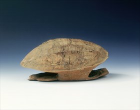 Petrified tortoise shell with oracle bone inscriptions, possibly Shang Dynasty, China, c1400 BC. Artist: Unknown