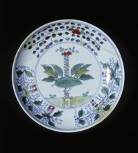 Doucai plate with pomegranate tree and floral groups, Qing dynasty, China, 1700-1722. Artist: Unknown