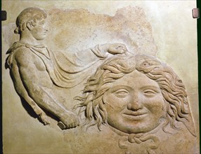 Roman fragment of a terracotta Campana relief showing head of Medusa with figure of Perseus. Artist: Unknown