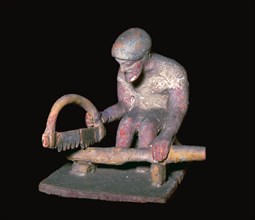 Greek terracotta figure of a man sawing wood, 6th century BC. Artist: Unknown