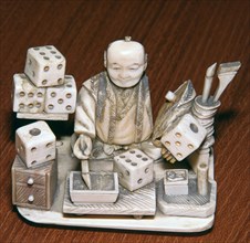 Japanese ivory of a dice painter, 19th century. Artist: Unknown