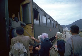 Local people boarding a train in Czechslovakia. Artist: CM Dixon Artist: Unknown