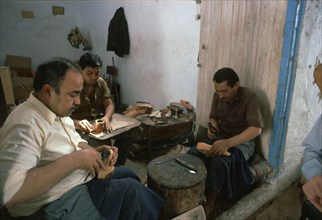 Shoemakers in a Tunisian souk. Artist: Unknown