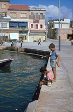 Children fishing in the harbour of Khania. Artist: Unknown