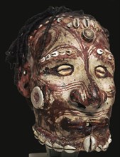 Human skull with features modelled in clay and painted, from New Guinea. Artist: Unknown