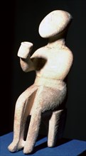 Cycladic marble seated figure holding a cup. Artist: Unknown