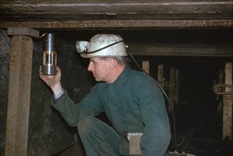 Pity Deputy tests for gas using Davy Safety Lamp.